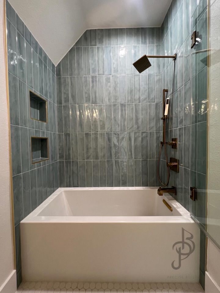 Completed luxury master bathroom with rectangular soaking tub and vertical teal tiling
