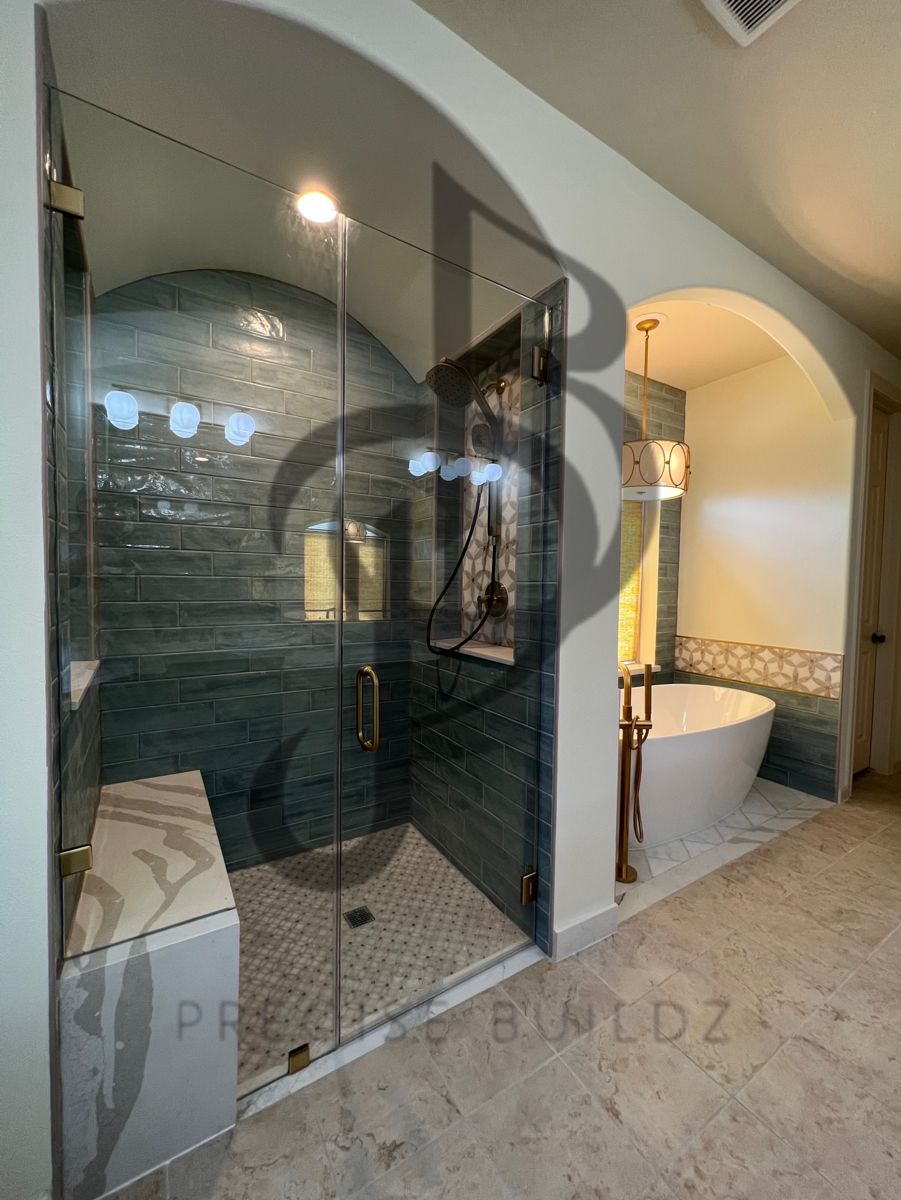 Completed luxury master bathroom with glass shower and freestanding tub