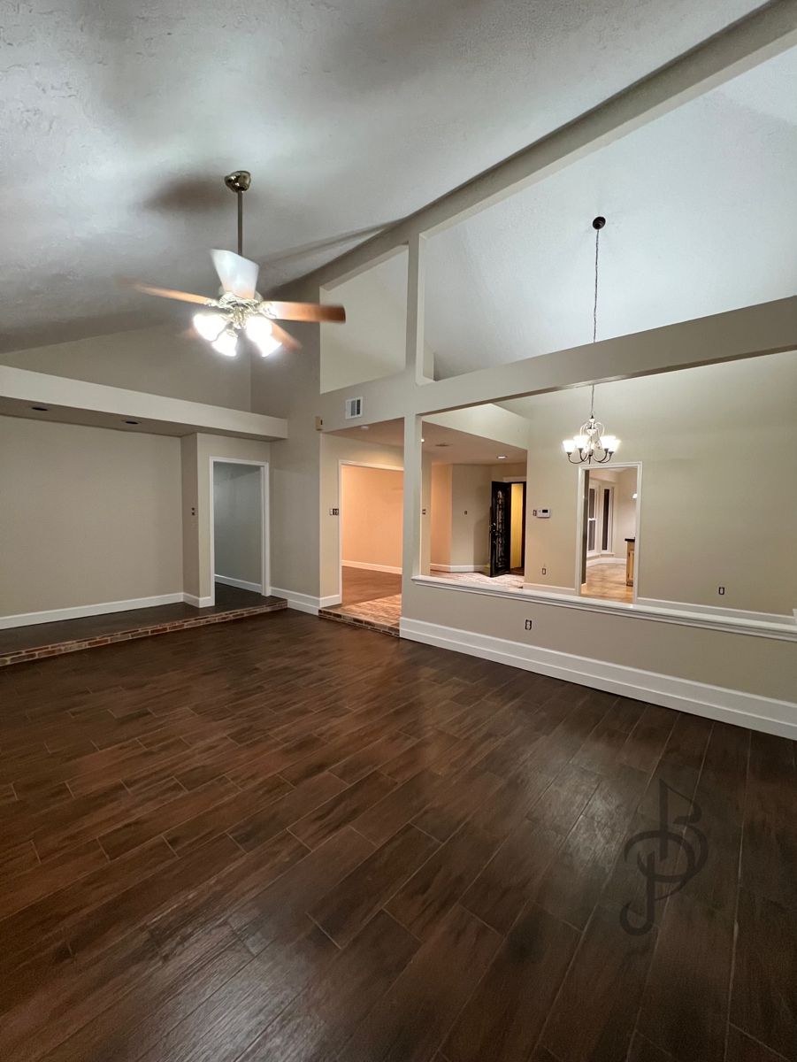 Spacious game room showcasing newly laid dark luxury vinyl plank flooring