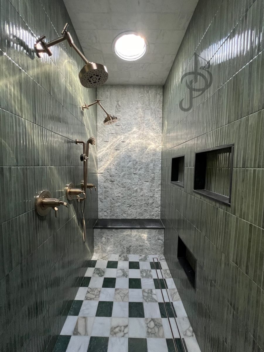 Luxury walk-in double shower with checkered marble floor and green tiles