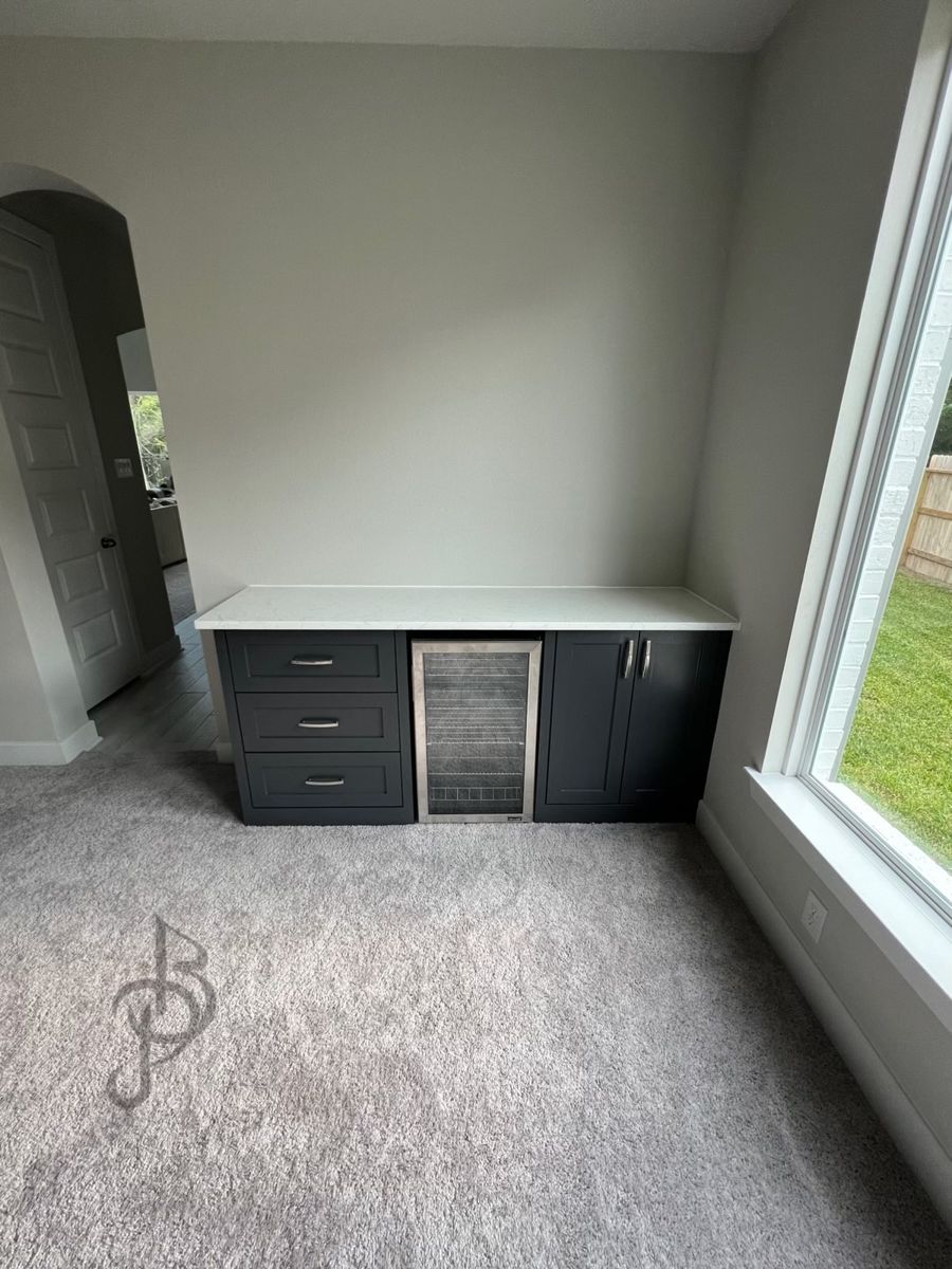 Custom dark grey bedroom wet bar console with integrated beverage cooler