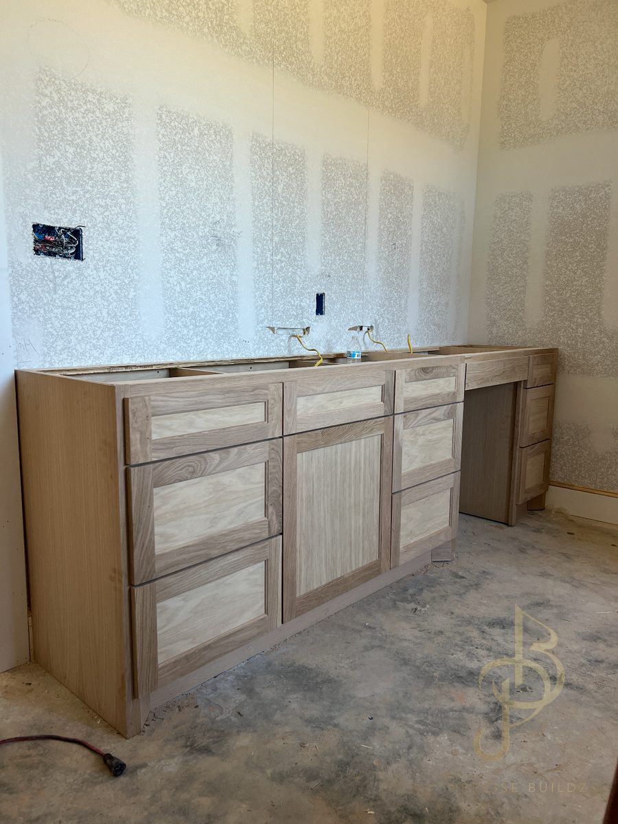 White oak shaker-style double vanity built in-shop, before counters and finish
