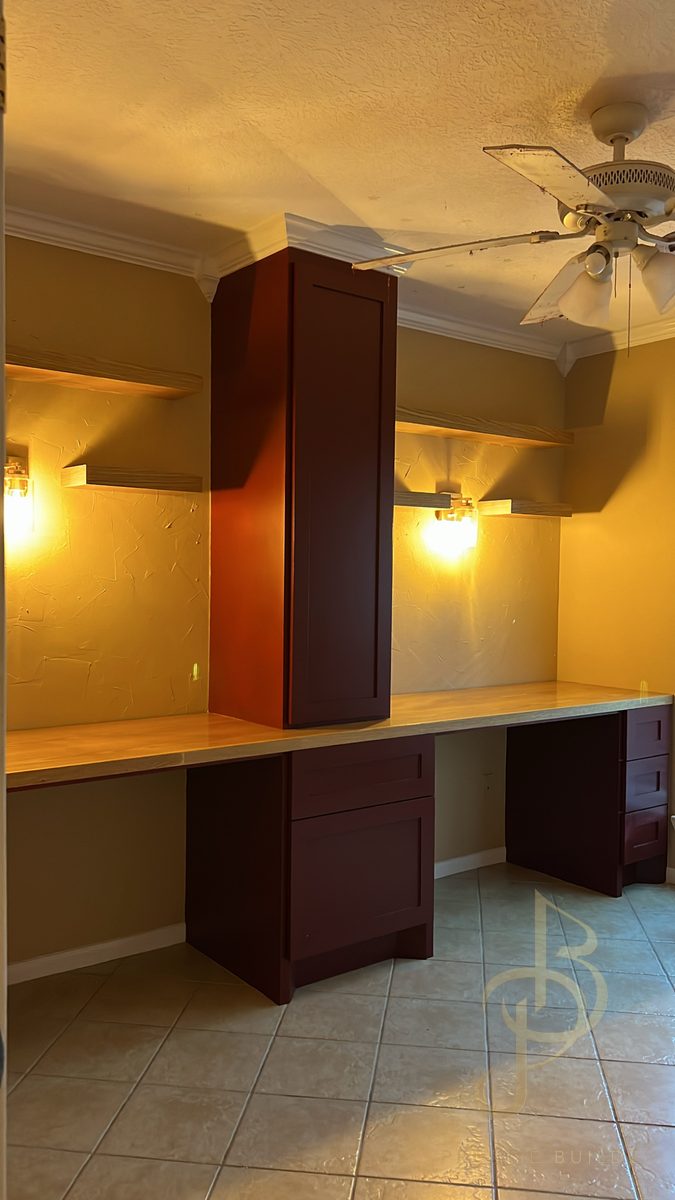 Custom home office built-in with tall storage cabinet and butcher-block desktops