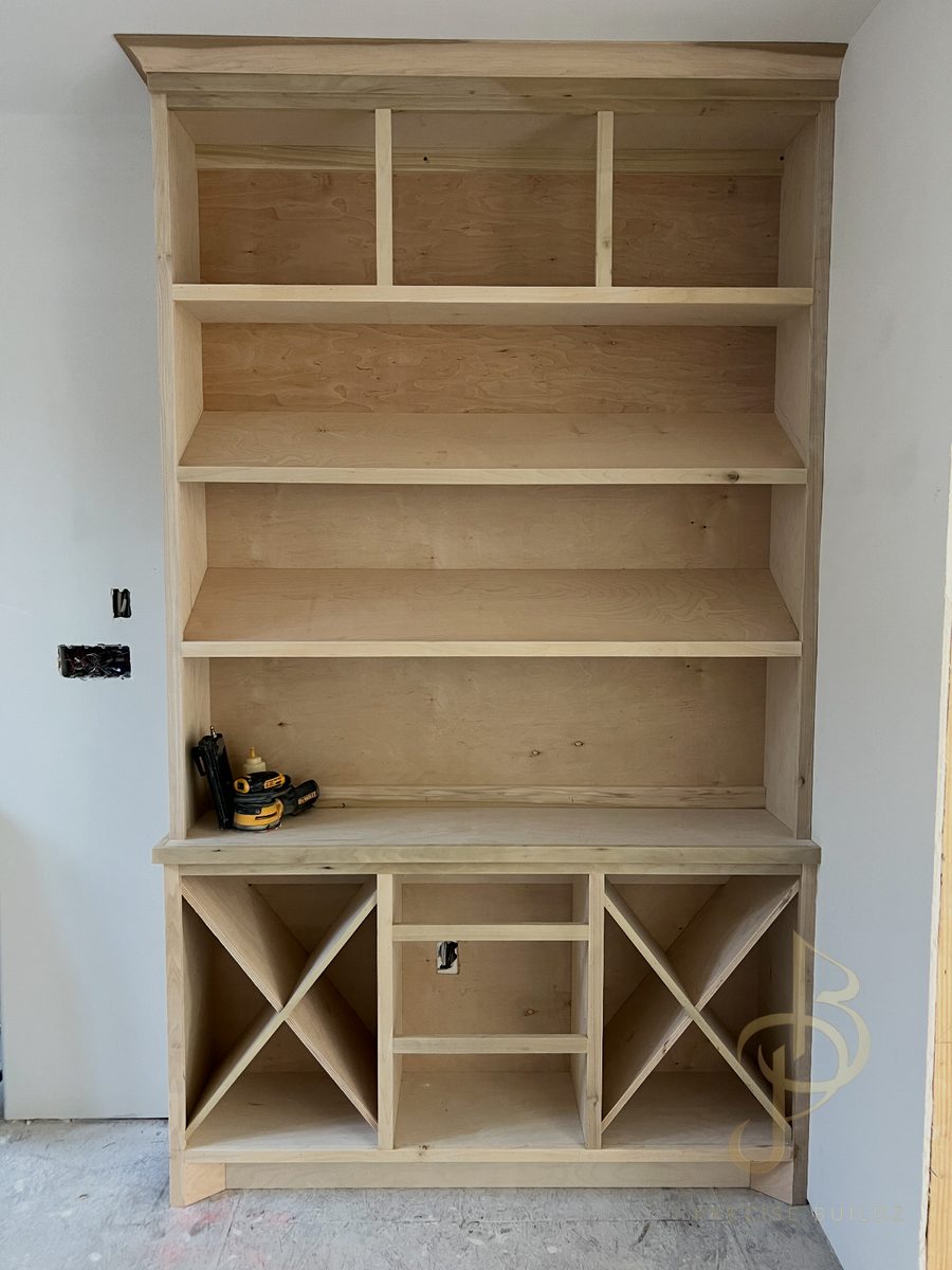 Custom built-in bookcase with X-pattern wine racks and display shelving